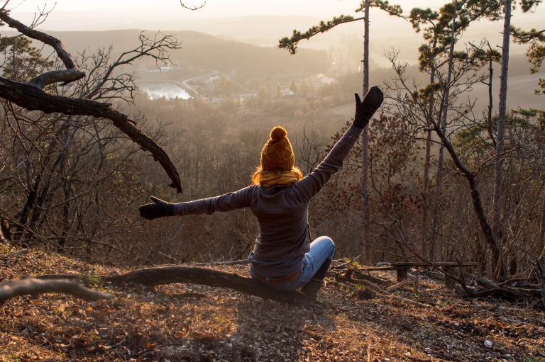 Girl sitting  in forest with beautiful view